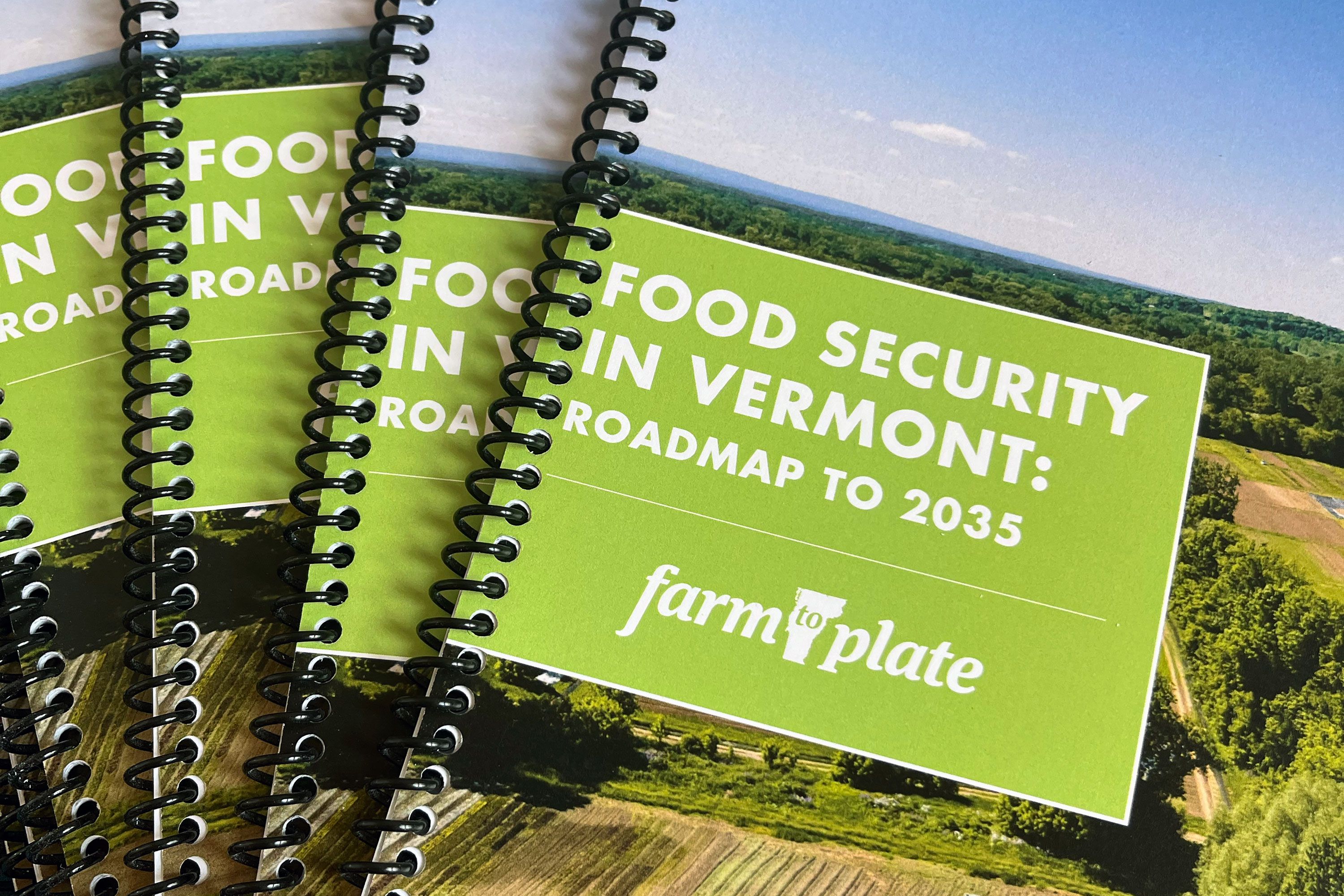 Four copies of the Vermont Food Security Roadmap fanned out on a table