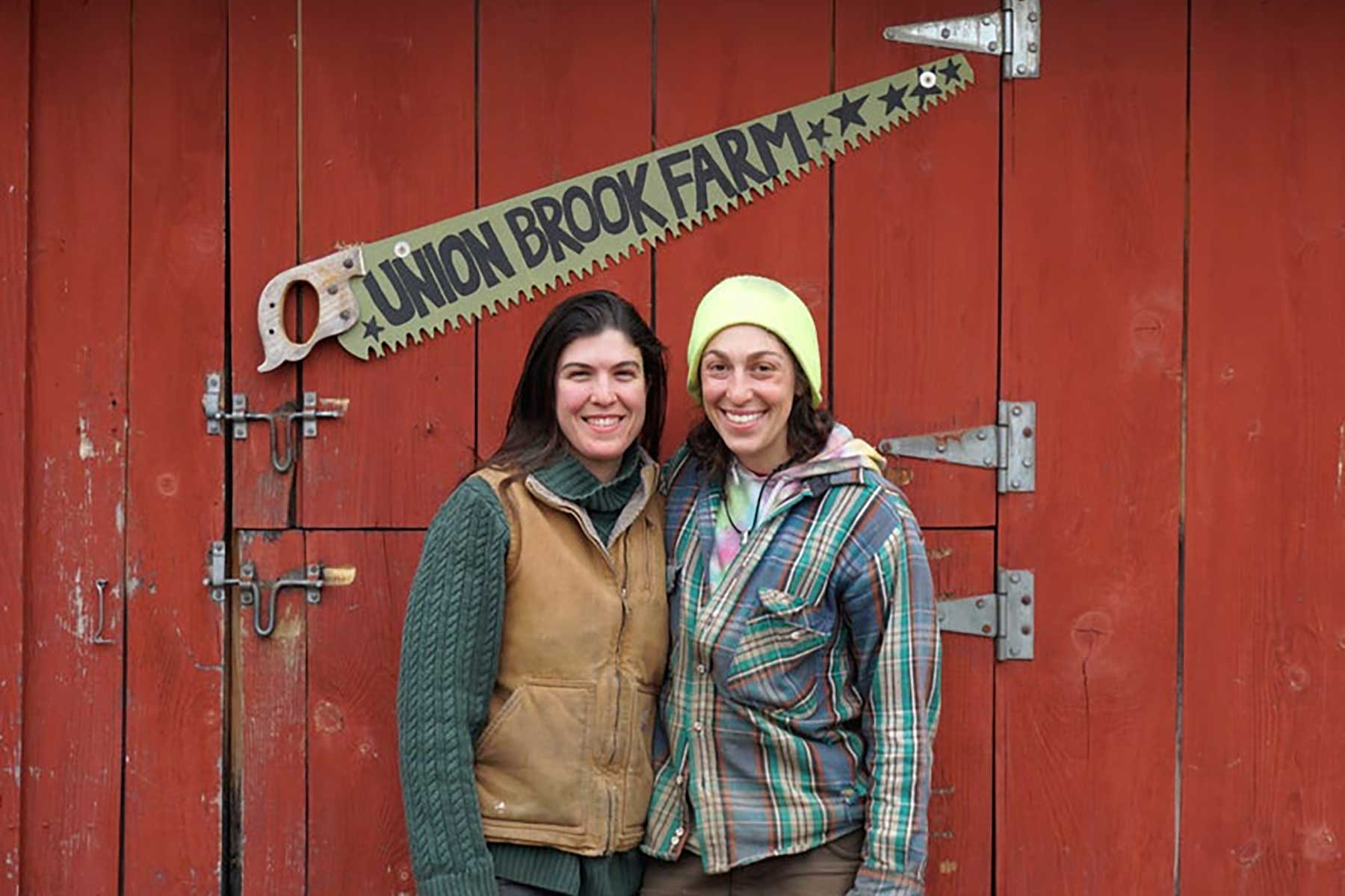 Union Brook Farmers in front of their red barn