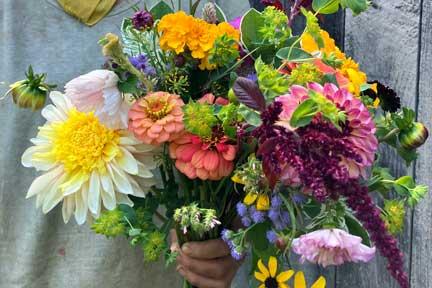 colorful fresh-cut flower bouquet held by farmer Laura Xiao of By Hand Farm